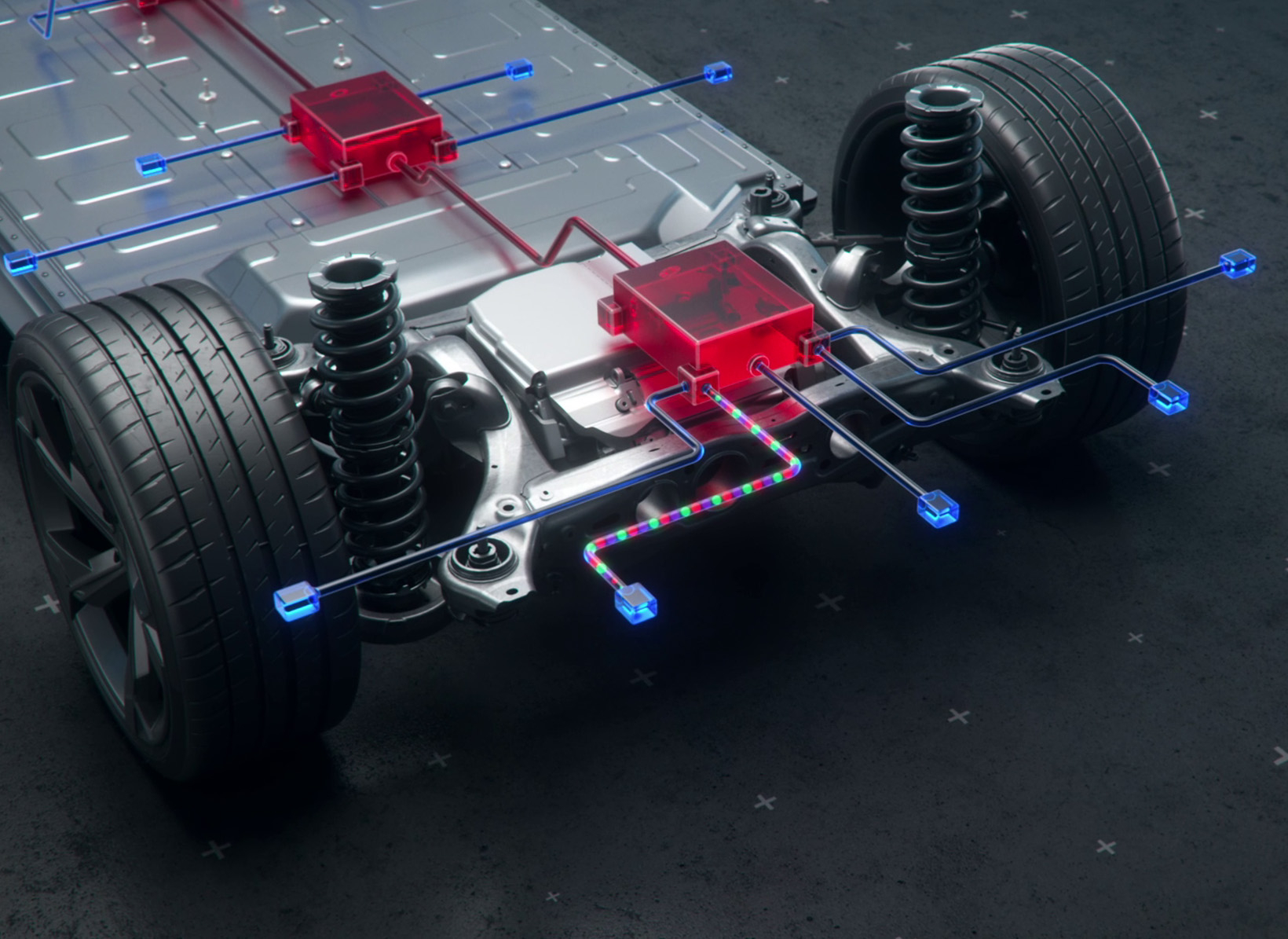 Das Bild zeigt eine technische Darstellung eines Elektrofahrzeug-Chassis mit Batterien und Kabeln, die die verschiedenen Komponenten miteinander verbinden.